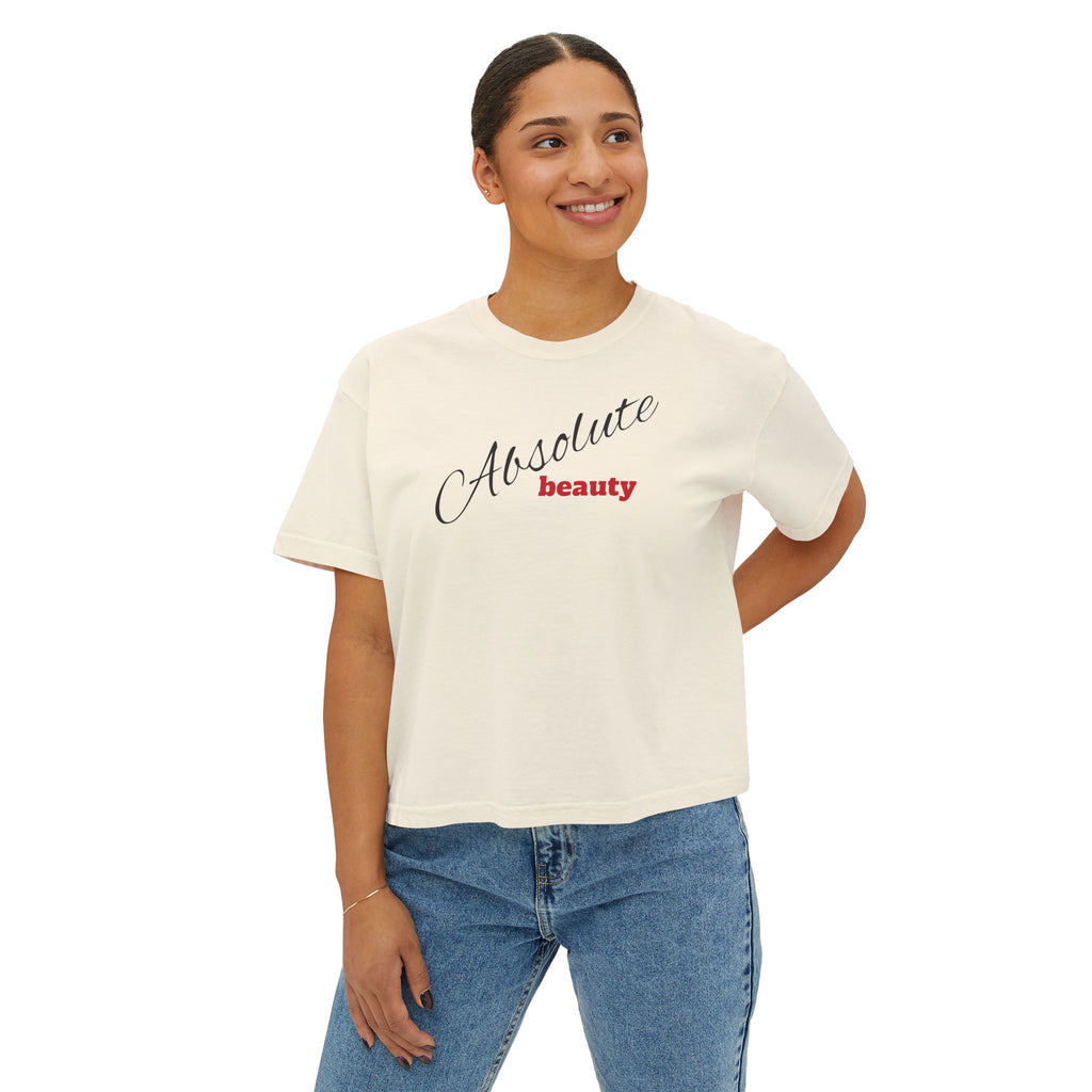 Woman wearing a white t-shirt with 'Absolute beauty' text, standing against a white background